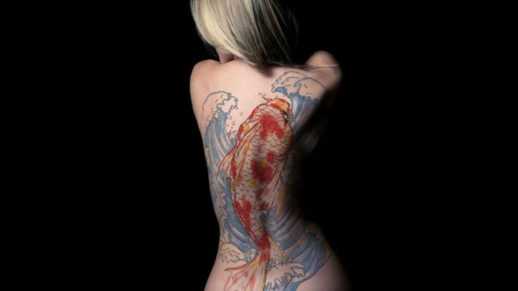 women koi fish tattoo in the back design